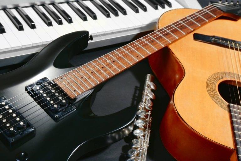 Uncle Dans Pawn Dallas image of musical instruments including a key board, electric, and acoustic guitar