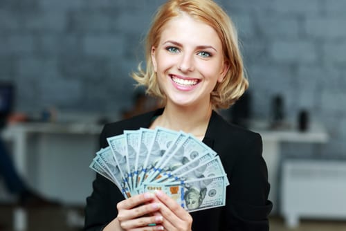 14-Day Interest Free Loan: Young woman smiling with cash